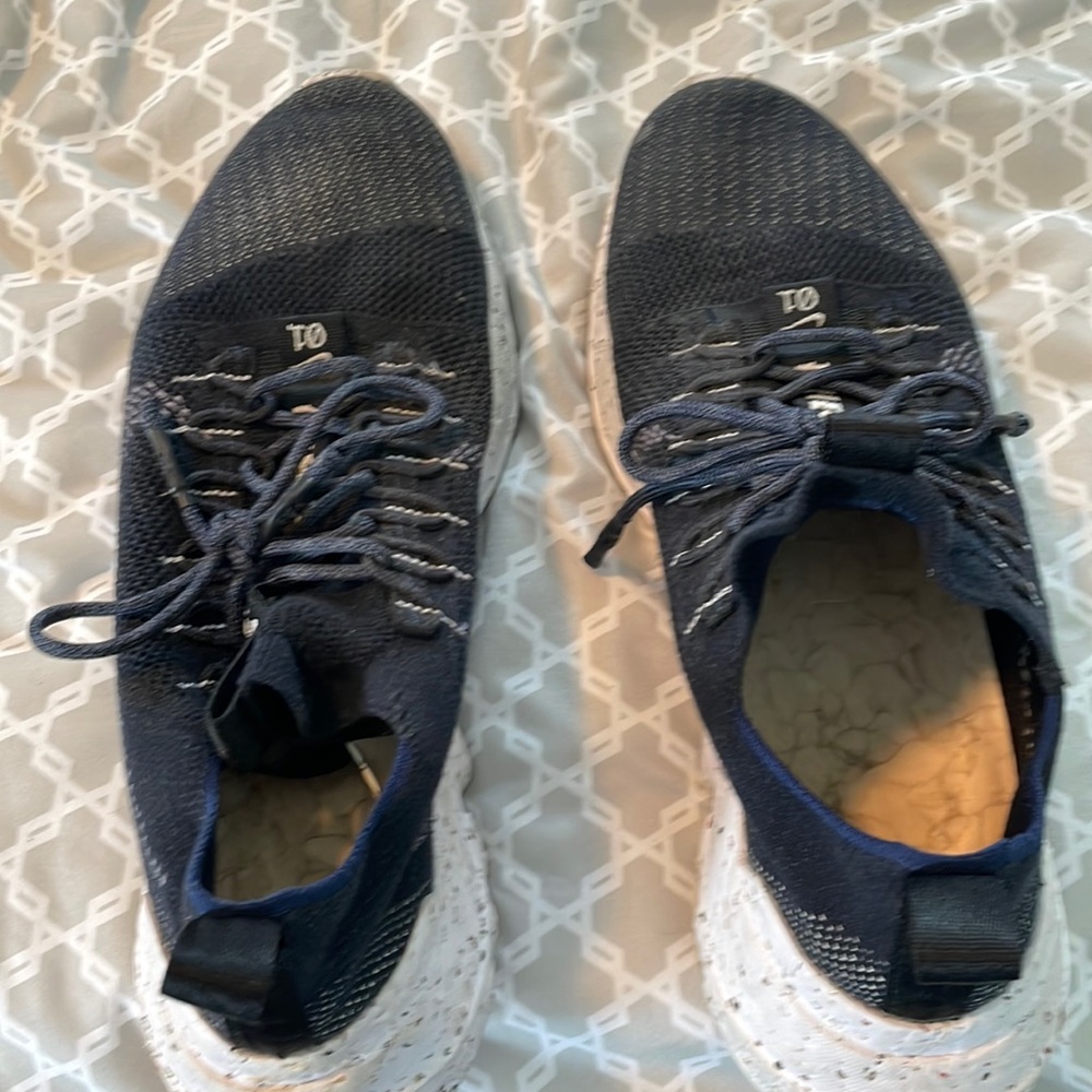 Mens Nike shoes, bottoms are made from recycled material.